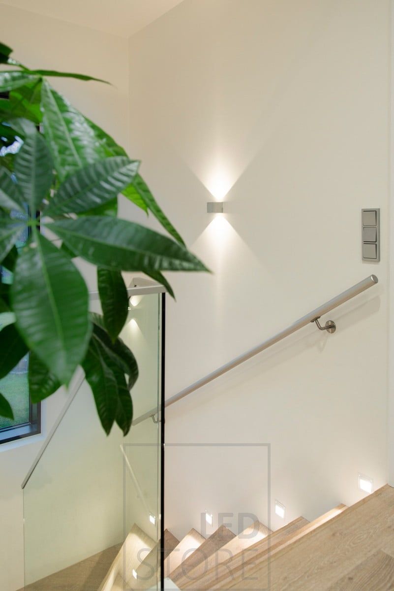 Bi-directional luminaires combined with stair tread lighting.